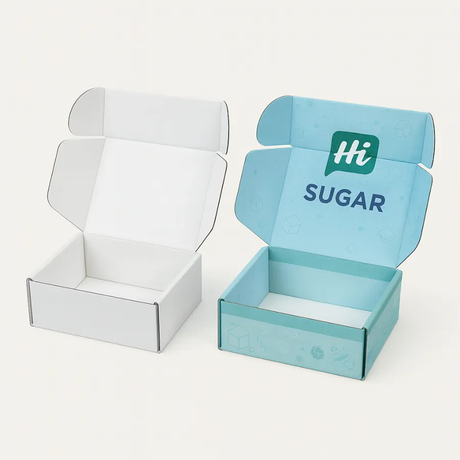 Two open flip-top cardboard boxes for sugar- one white and one with bright blue branding- class=